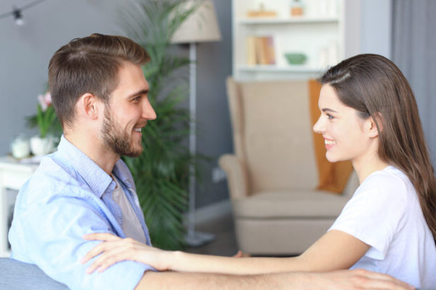 couple man woman sofa looking each other